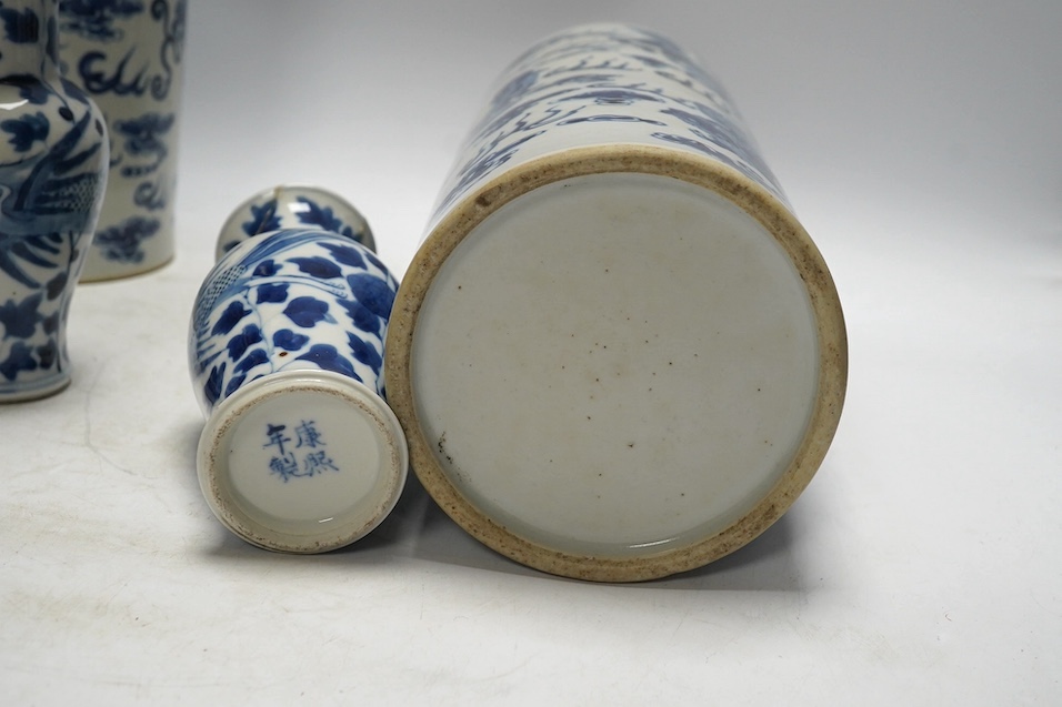 A pair of Chinese blue and white cylindrical brushpots and a smaller pair, tallest 29cm. Condition - both smaller vases with heavy repairs